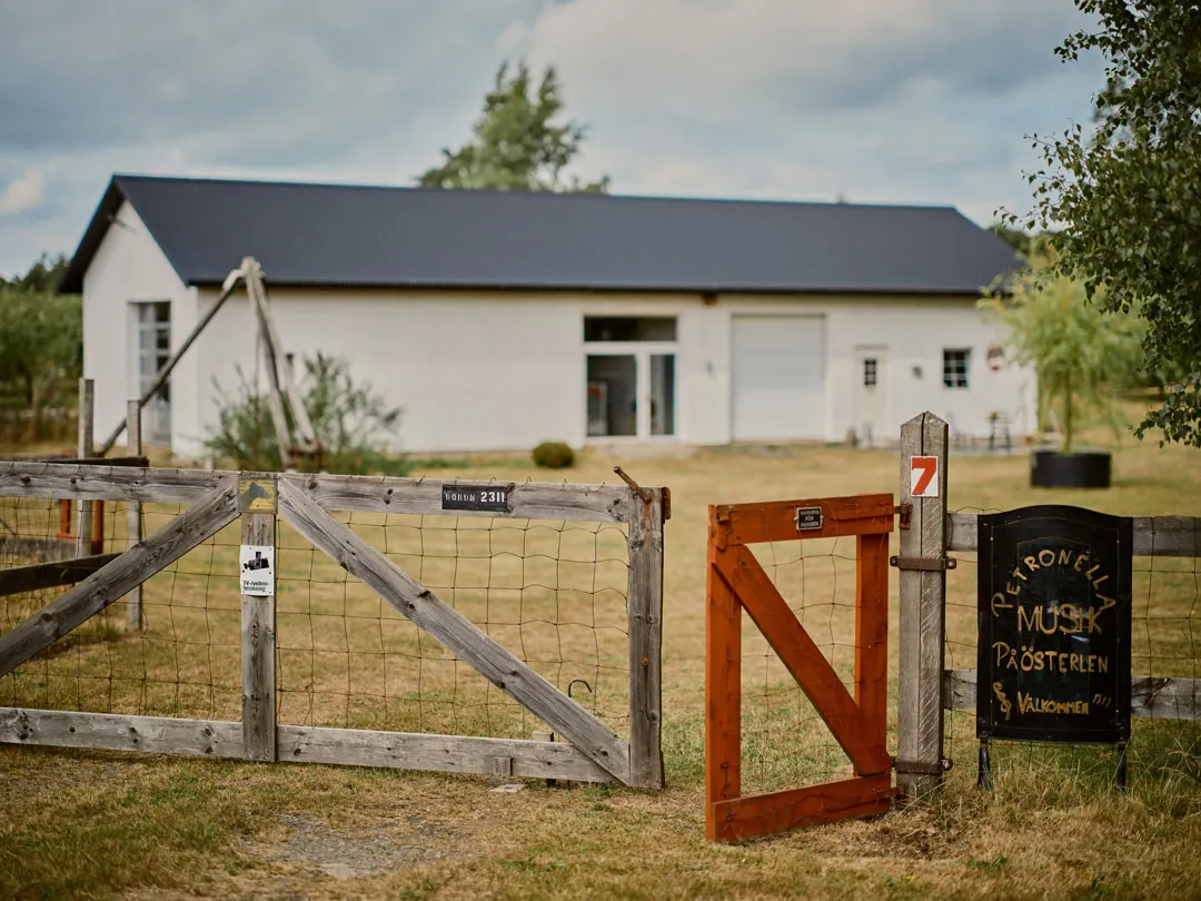 a fence and gate in front of a white house